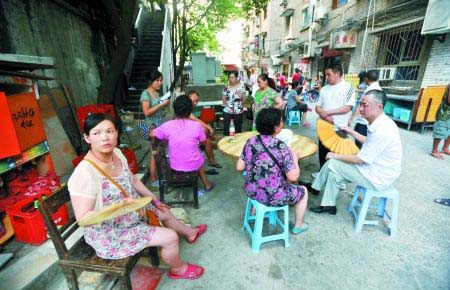 Scared residents are waiting outside the buildings. 