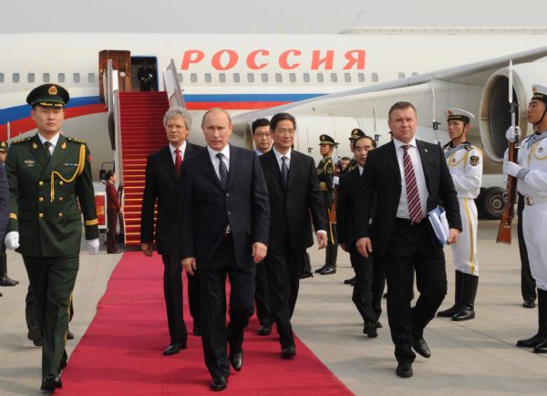 Russian Prime Minister Vladimir Putin (2nd L, front) arrives in Beijing for an official visit to China, Oct. 11, 2011. During the visit, Putin will attend the 16th regular meeting between the two coun