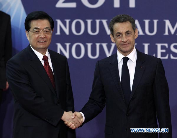 Chinese President Hu Jintao (L) shakes hands with his French counterpart Nicholas Sarkozy during their meeting in Cannes, France, Nov. 2, 2011. Hu Jintao was here to attend a Group of Twenty (G20) sum