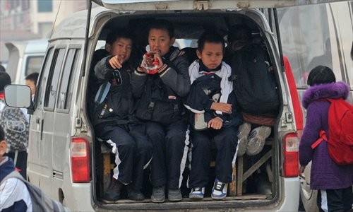 Pupils from a Tianjin primary school are crammed into a school bus adapted from a minivan on November 21. Photo: IC