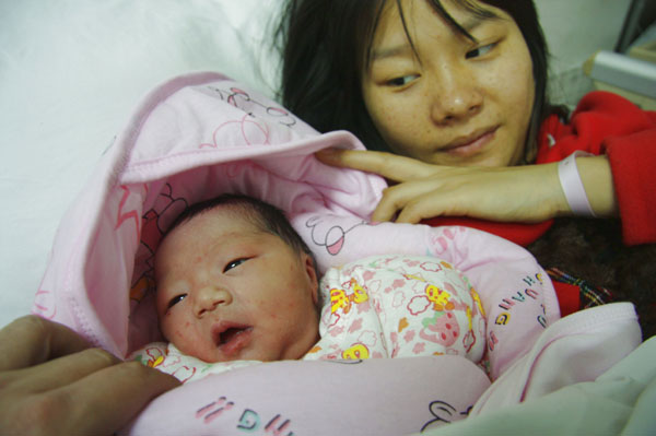 Feng Yu smiles at her newborn daughter at Tongji Hospital in Wuhan.