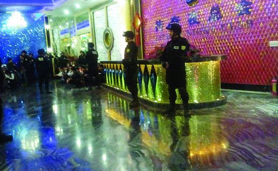 Armed police officers on guard inside Chuanqi Nightclub in Dongguan, Guangdong province, on Tuesday. Shenzhen police were attacked at the club when they were chasing a suspect.