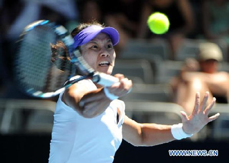 Li Na of China hits a return during the 1st round of women's singles match against Kazakhstan's Ksenia Pervak on day 1 of 2012 Australian Open tennis tournament at Melbourne Park.