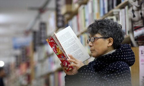 A Chinese man reads a book at a bookstore during Spring Festival.