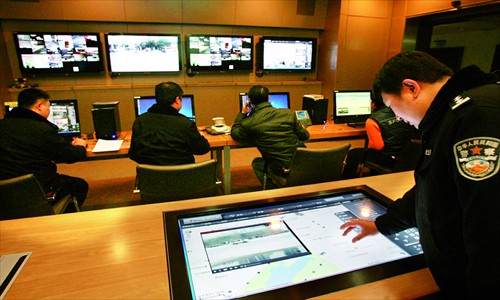 Police officers look over streets with security cameras. [Photo: CFP]