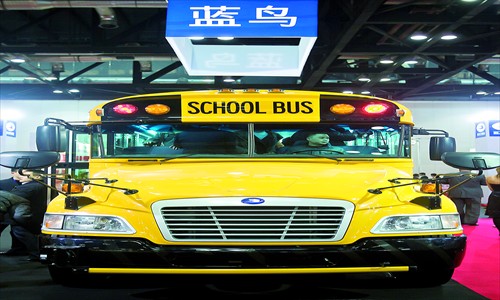 Visitors to a school bus fair check out a model Wednesday at China National Convention Center, Chaoyang district. Manufacturers see market opportunities as Chinese law makers mull mandated school buses. Photo: CFP 