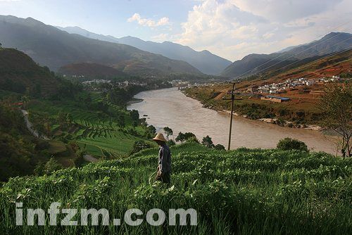 A farmer is working in his field near the Nujiang River.