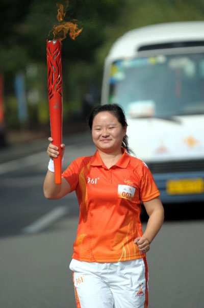 Wu Xingfen carries the 2010 Asian Games torch. 