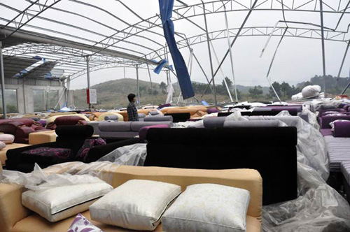 The roof of a furniture warehouse was torn away by gusts of wind in Lianzhou, South China's Guangdong province, April 5, 2012. [Photo/Xinhua]