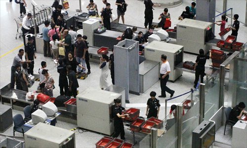 Passengers go through security at Beijing Capital International Airport in August last year. [Photo: CFP]