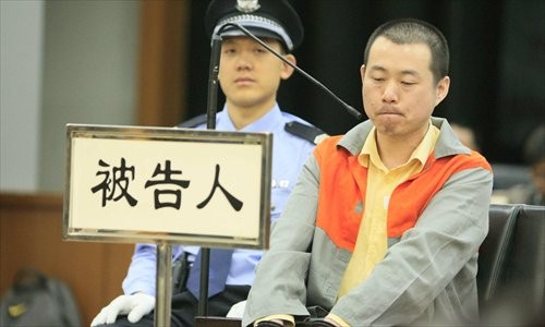 Wang Jinsheng sits in the dock on Monday for the alleged murder of his father.