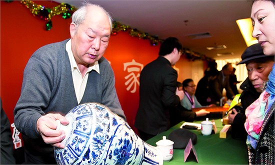 An antique specialist examines a vase amateur collectors have brought to him in a collectors' conference in November 2011. Expert testimonies on the authenticity of artifacts are highly valued but not always correct.