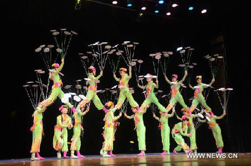 Acrobats from Chinese national acrobatic troupe perform Plates Spinning during a fund-raising show for Myanmar Library Foundation at the National Theatre in Yangon, Myanmar, April 29, 2012. (Xinhua/Jin Fei)