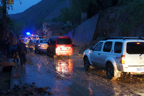 A road linking the Minxian County and Chabu Town was blocked after a hail and rain storm in the Minxian in northwest China's Gansu Province. [Photo: Xinhua]