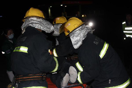 Rescuers work at the accident site after a coach collided with a truck in Ulanqab City, north China's Inner Mongolia Autonomous Region, May 14, 2012. At least four people were confirmed dead and more than 30 others were injured in the accident which happened early Monday morning. (Photo: Xinhua/Wang Chao)