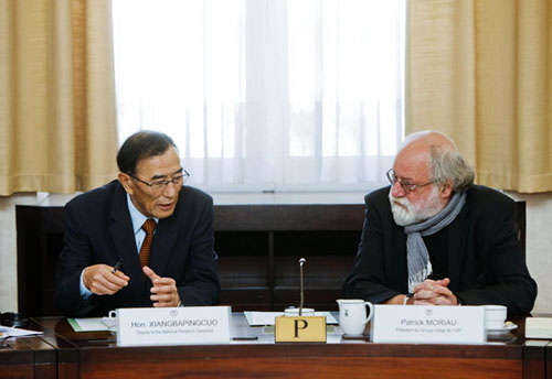 Qiangba Puncog, head of the standing committee of the Tibet autonomous region's people's congress, talks with Patrick Moriau, member of the house of representatives of Belgium, in Brussels, on Tuesday. Zhou Lei / Xinhua