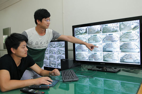 Workers check the surveillance devices of exam rooms at a school in Zhuji city, Zhejiang province, on Tuesday. Provided to China Daily