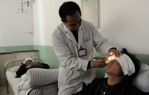 A survived prospecting worker receives medical treatment in Subei County, northwest China's Gansu Province, June 7, 2012. Ten prospecting workers were confirmed dead in an avalanche occurred late Tuesday night at the campsite of the Heicigou Antimony Ore 