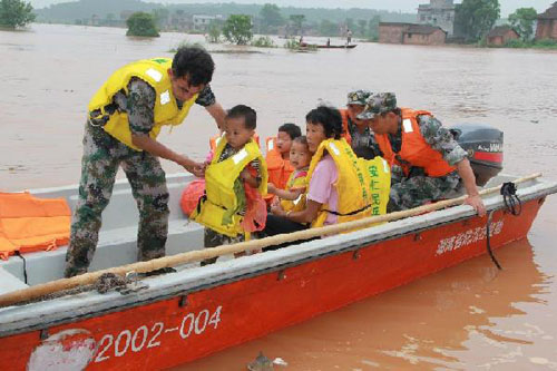 Residents are evacuated in Anren County, central China's Hunan Province, June 11, 2012. Torrential rains swept across Hunan over the past few days, killing nine people and affecting 1.1 million, local authorities said on Tuesday. (Xinhua/Li Xiwan)