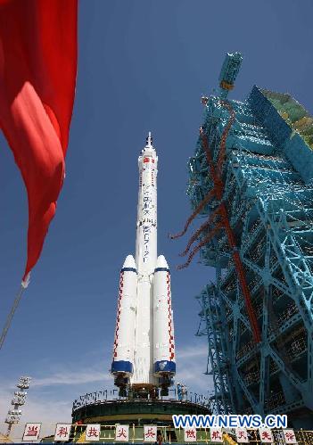 The Shenzhou-9 manned spacecraft, the Long March-2F rocket, and the escape tower are vertically transferred to the launch pad at the Jiuquan Satellite Launch Center in northwest China's Gansu Province, June 9, 2012. China will launch its Shenzhou-9 manned spacecraft sometime in mid-June to perform the country's first manned space docking mission with the orbiting Tiangong-1 space lab module, a spokesperson with the country's manned space program said here Saturday. (Xinhua/Wang Jianmin)