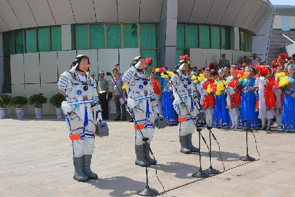 China's taikonauts Jing Haipeng (C), Liu Wang (R) and Liu Yang attend the see-off ceremony at the taikonauts' apartment compound of the Jiuquan Satellite Launch Center in Jiuquan, northwest China's Gansu Province, June 16, 2012. 