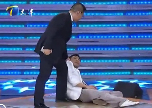 Guo Jie passes out on stage during a stern line of questioning by the panel of executives.