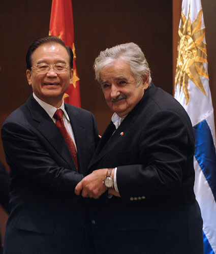 Premier Wen Jiabao greets Uruguayan President Jose Alberto Mujica during the signing ceremony for bilateral agreements in Montevideo, Uruguay, on Friday. 