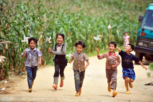 Children play with homemade pinwheels after taking their final exams in Dahua Yao autonomous county, South China's Guangxi Zhuang autonomous region, July 4, 2012. [Photo/Xinhua]