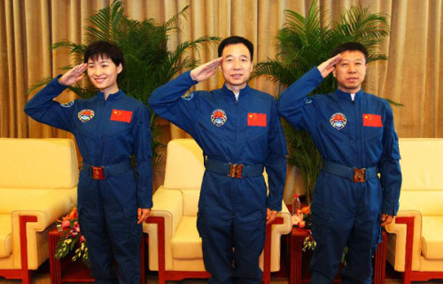 Jing Haipeng (C), commander of the Shenzhou-9 spacecraft, Liu Wang (R) and Liu Yang, China's first female in space, salute in front of the media in Beijing, capital of China, July 13, 2012. After a two-week quarantine and recovery, three Chinese astronauts that successfully fulfilled China's first manned space docking mission appeared in public on Friday. (Xinhua/Zha Chunming)