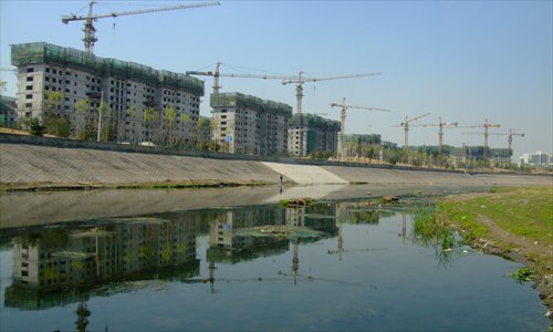 New residential buildings rise up beside the Tonghui River in eastern Beijing. 