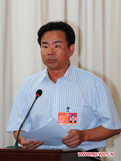 Xiao Jie, the first mayor of the newly established Sansha city, speaks in the first session of the first Sansha Municipal People's Congress held on Yongxing Island, the government seat of Sansha City, in south China's Hainan province, July 23, 2012. [Xinh