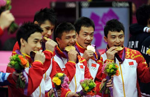 China's gymnasts celebrate after winning the men's gymnastics team final in the North Greenwich Arena during the London 2012 Olympic Games July 30, 2012. [Photo/Xinhua]