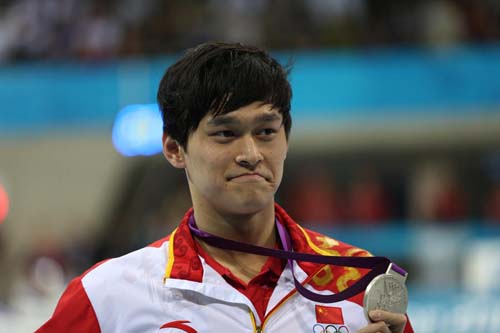 Sun Yang of China poses at the awarding ceremony of men's 200m freestyle of swimming at the London 2012 Olympic Games in London, Britain, July 30, 2012. Sun Yang of China and Park Taehwan of South Korea shared silver medal with 1:44.93. (Xinhua/Fei Maohua)