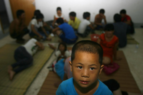 Li Ting, 6, and his family members, stay at a temporary shelter as a typhoon warning is issued in Cangnan couty, East China's Zhejiang province on August 2, 2012.