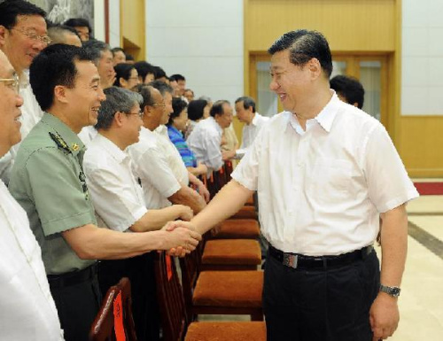 Chinese Vice President Xi Jinping (R) greets a group of renowned experts and grassroots talents in Beidaihe, north China's Hebei Province, Aug. 5, 2012. Those experts and talents were invited by the central authority to a routine high-profile holiday program in Beidaihe, a popular northern seaside resort close to the Chinese capital, as a form of recognition and reward for their works.