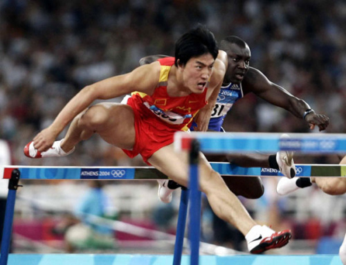 Liu Xiang, left, sprints to win the men's 100m hurdles at the Athens Olympic Games, Aug 27, 2004 file photo.