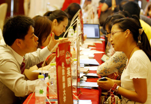 Visitors consult information on studying abroad at an international education exhibition in Nanjing, Jiangsu province, in July. About 90 universities from 12 countries took part in the exhibition. 