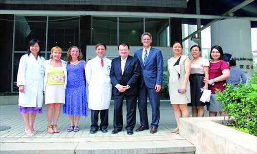 Luc Montagnier (middle) with employees from BJU. (Photo: Courtesy of Beijing United Family Hospital) 