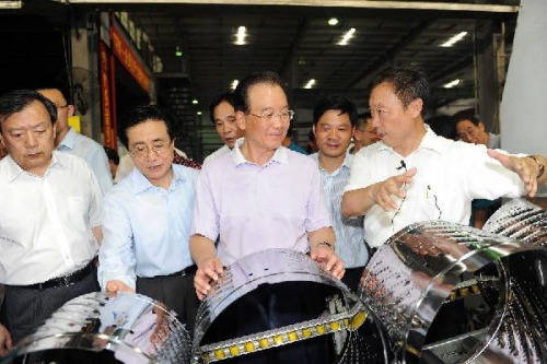 Chinese Premier Wen Jiabao (3rd L, front) visits the factory of Hisense-Whirlpool (Zhengjiang) Electric Appliances Co., Ltd in Huzhou, east China's Zhejiang Province, Aug. 14, 2012. Wen made an inspection tour in Zhejiang on Tuesday and Wednesday. (Xinhua