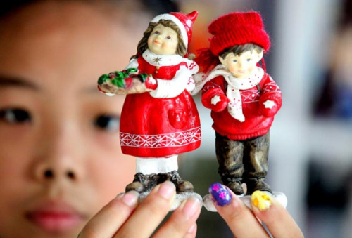 A girl displays lovers' ornaments at a jewelry store on August 19, Bozhou city, Anhui province. [Liu Qinli/Asianewsphoto] 