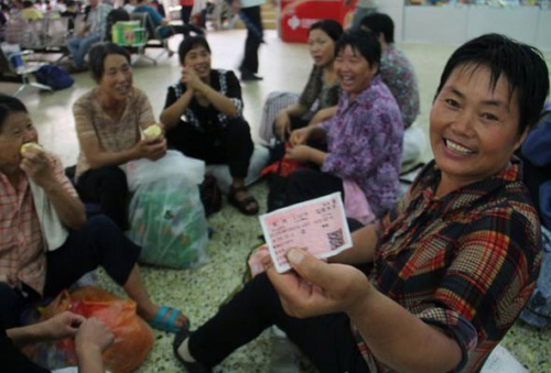 A farmer (R) from Ruyang, Henan province shows her ticket as she waits to board the L147 train to pick cotton in Xinjiang A farmer (R) from Ruyang, Henan province shows her ticket as she waits to board the L147 train to pick cotton in Xinjiang Uygur auton