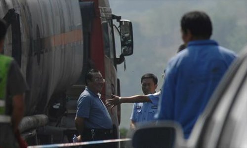 An online photo shows Yang Dacai, an official in charge of workplace safety in Shaanxi Province, was caught smiling during his inspection of a road accident in Yan'an, Shaanxi on August 26. 