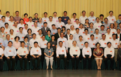 Jia Qinglin (C bottom), chairman of the National Committee of the Chinese People's Political Consultative Conference, poses for a group photo with attendees during the opening ceremony of a symposium on the political consultation theory research work in B