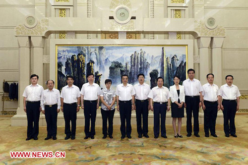 Chinese Vice Premier Li Keqiang (6th L) meets with a report team on deeds of Meng Xiangmin, a heroic environmental protection inspector in east China's Shandong Province, in Beijing, capital of China, Sept. 5, 2012.