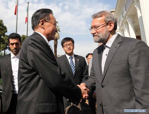 Wu Bangguo (L front), chairman of the Standing Committee of China's National People's Congress, is welcomed by Iranian Parliament Speaker Ali Larijani at the entrance to Iranian parliament building before their talks in Tehran, Iran, Sept. 10, 2012. (Xinhua/Liu Weibing) 