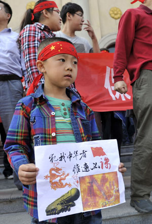 A boy takes part in a protest in Taiyuan, the capital of Shanxi province, on Sept 15. He was one of thousands of protesters across China who voiced their displeasure over Japan's claims on the Diaoyu Islands. Wei Liang / China News Service