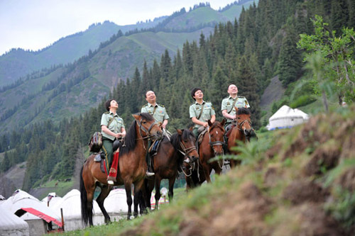 Zhuang Shihua, 2nd from left, leads a medical squad offering free medical consultation to people in a remote village in Urumqi, Xinjiang Uygur autonomous region, June 18, 2012. [Photo/Xinhua]  