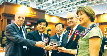 Michel Humbert (second from right), consultant for the Yantai government, talks with friends at an expo in the city.