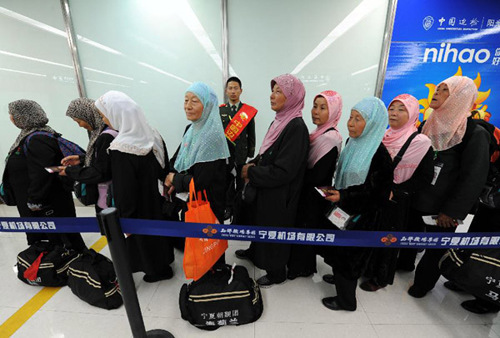 Muslims in Ningxia going for Mecca pilgrimage wait to board the charter flight at Hedong Airport in Yinchuan, capital of northwest China's Ningxia Hui Autonomous Region, Oct. 7, 2012. The first group of 332 Muslims in Ningxia going for pilgrimage in Mecca