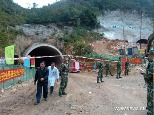 Photo taken with a mobile phone on Oct. 10, 2012 shows rescuers working at the accident site after an expressway tunnel collapsed at the section of Najia Township in Debao County, along the expressway between Baise City and Jingxi County in southwest China's Guangxi Zhuang Autonomous Region. Five people were dead and another injured in the accident, which occurred early Wednesday. Seven people were working within the tunnel under construction when the accident occurred. One escaped and six others were buried, according to local authority. (Xinhua/Ding Wen'gang)